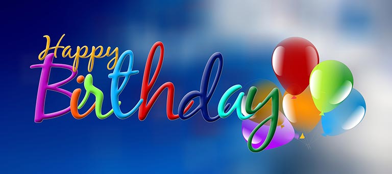 Happy birthday text with balloons on a background with blue sky and clouds