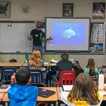 George T. Probst talking with elementary school students about sharks